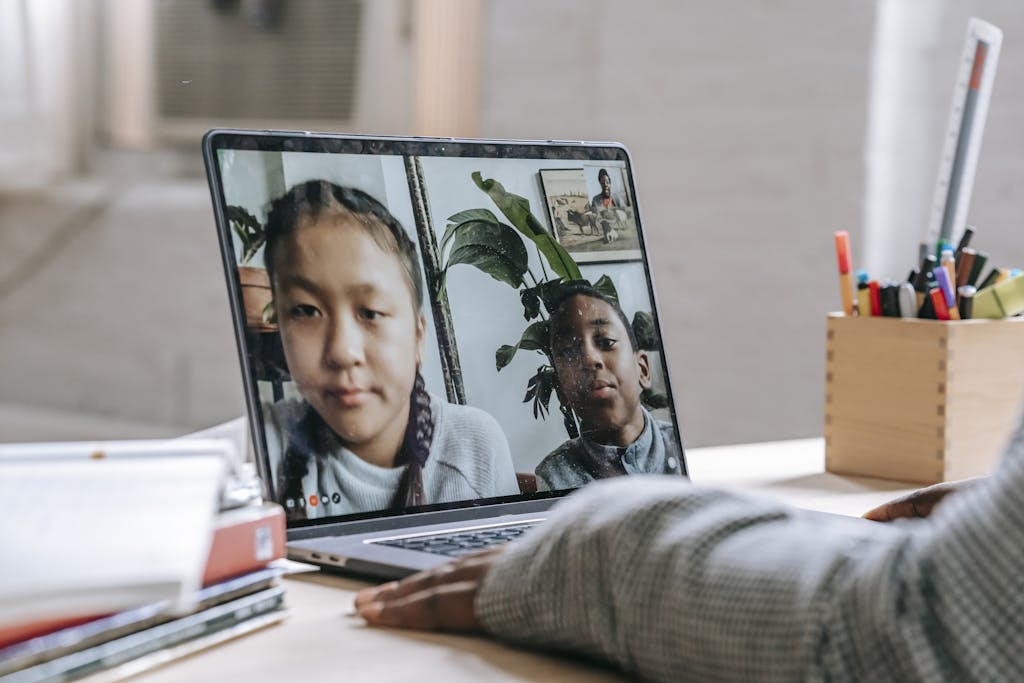 Children participating in a virtual learning session on a laptop, showcasing remote education during isolation.